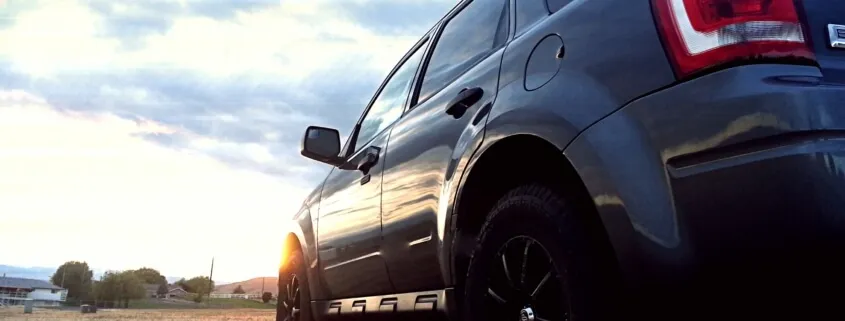Black SUV at sunset
