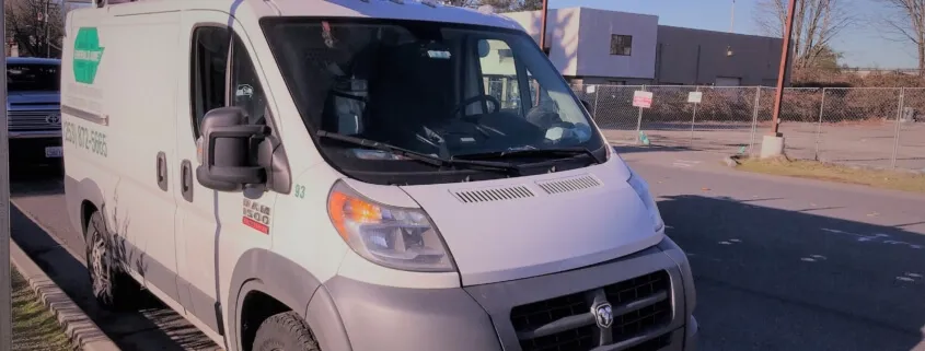 White delivery van parked on street