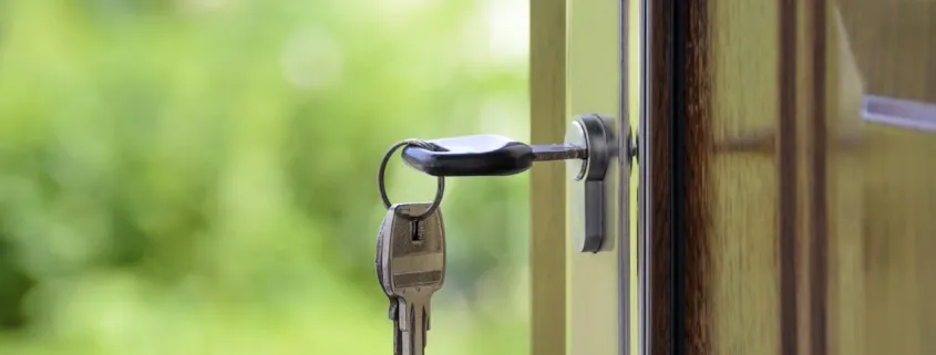 House key hanging in door lock